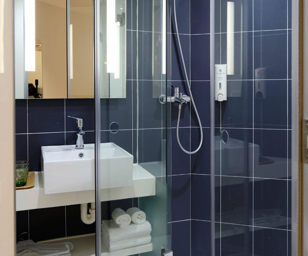 Bathroom shower with sink and shelves