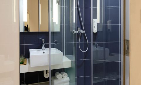 Bathroom shower with sink and shelves