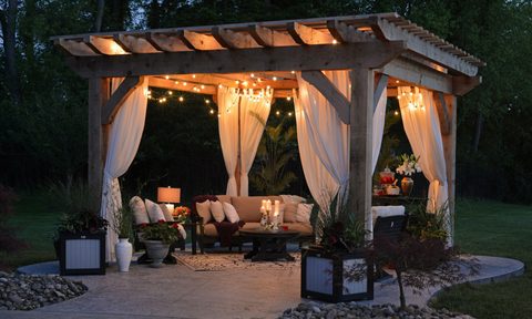 Backyard pergola with lights at night