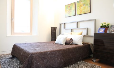 Artwork, headboard, and nightstand in bedroom