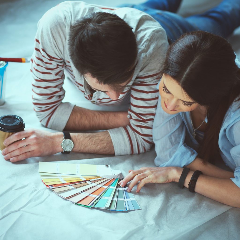 Man and woman looking at paint samples