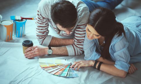 Man and woman looking at paint samples