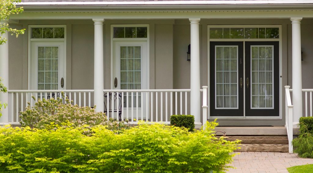 Home with porch and bushes