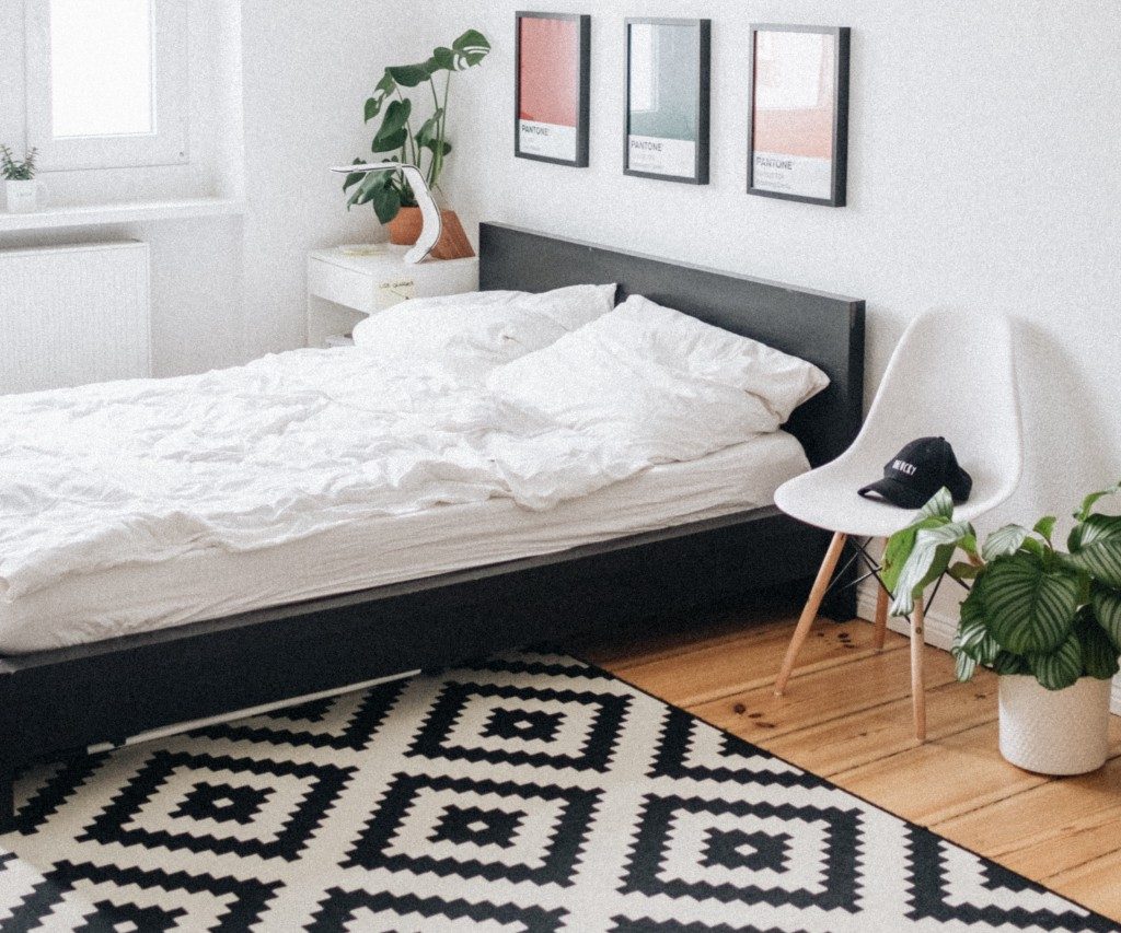 Bedroom with bed, carpet, and chair