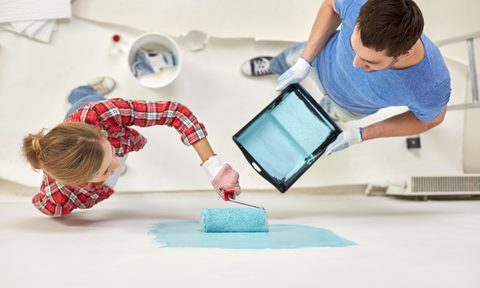 Woman and man painting a wall