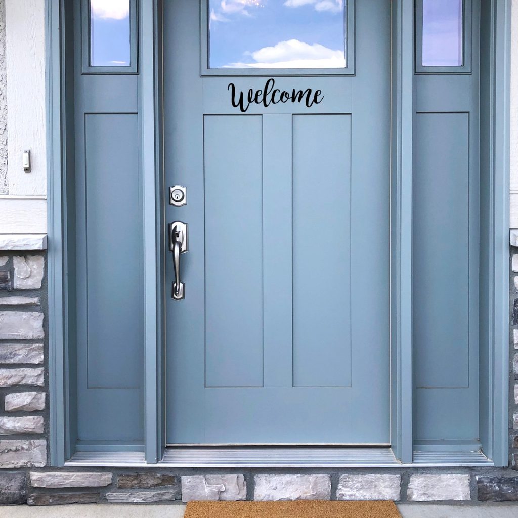 Blue door with "Welcome" sign