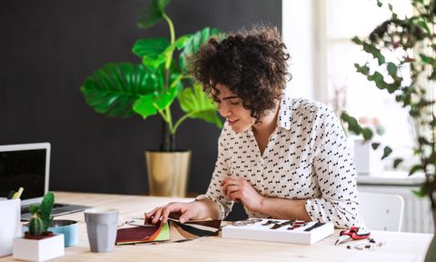 Woman at desk looking at paint samples