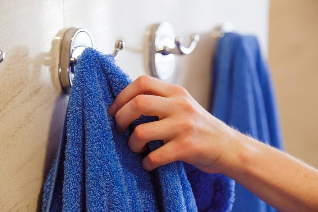 Towel hook with blue towels hanging
