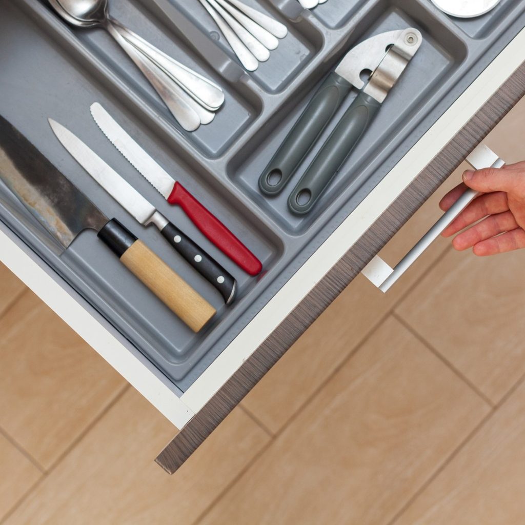 Person opens an organized kitchen drawer