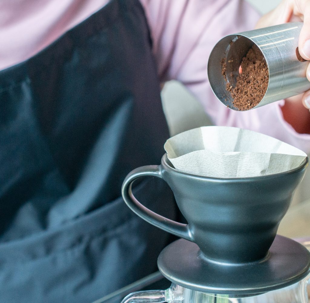 person preparing pour over coffee