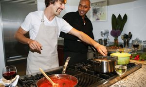 two men cooking at stove