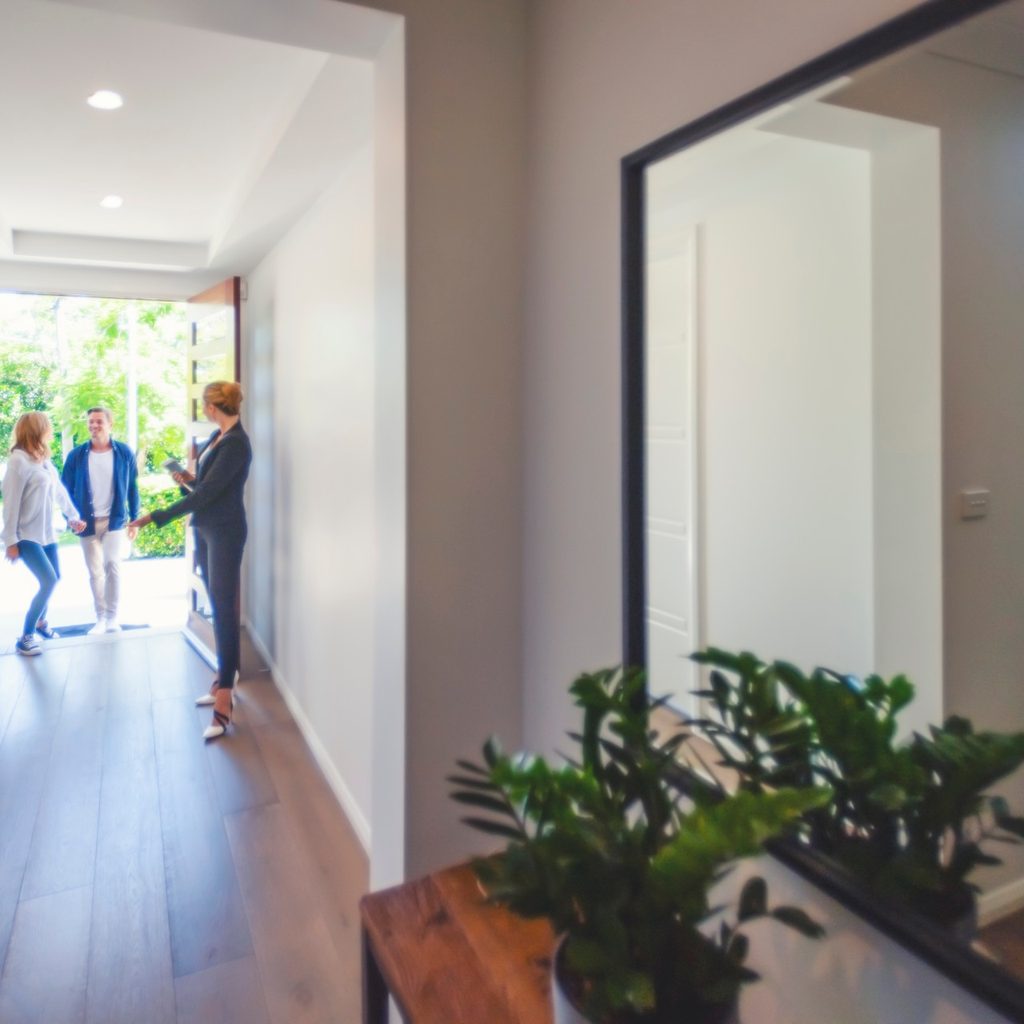 Woman welcoming friends at the front door