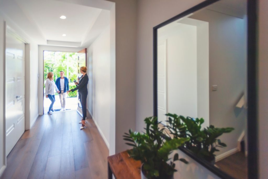 Woman welcoming friends at the front door