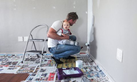 man painting with baby