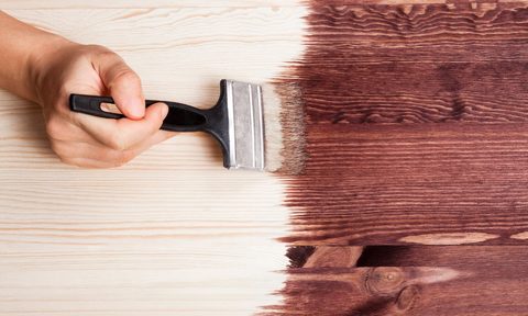 Wooden table being painted brown