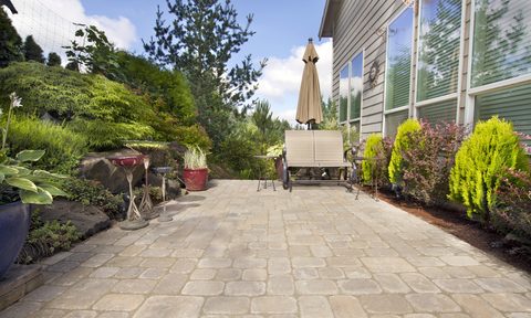 Backyard cement paver patio with bench