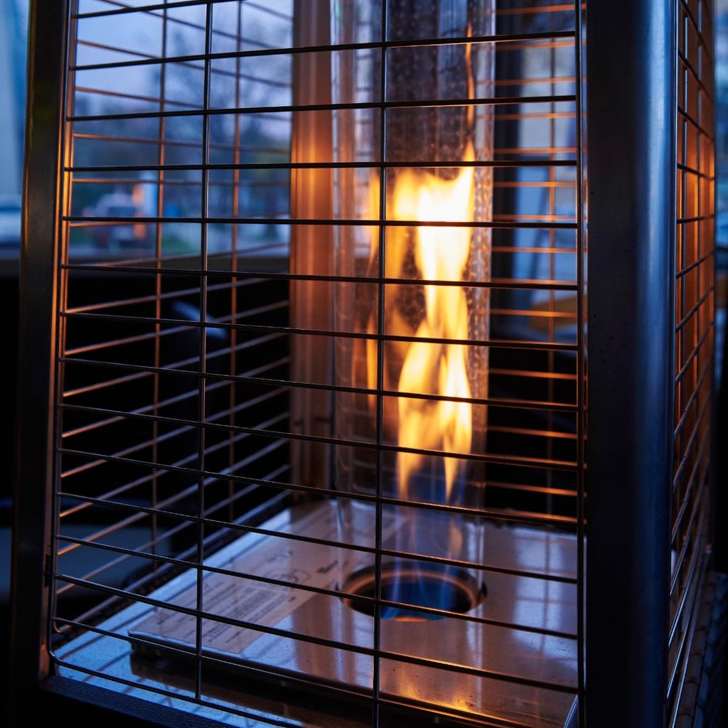 Tall outdoor heater at night