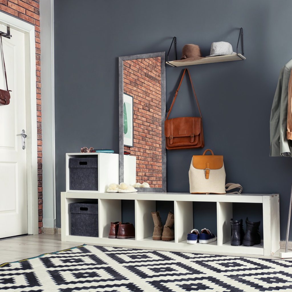 Home with door, rug, mirror, and coat rack
