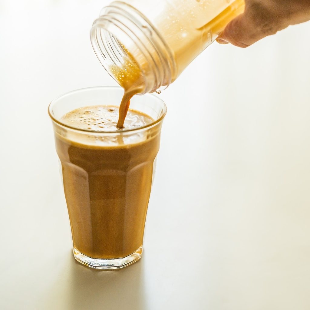 Bulletproof coffee poured into a glass mug