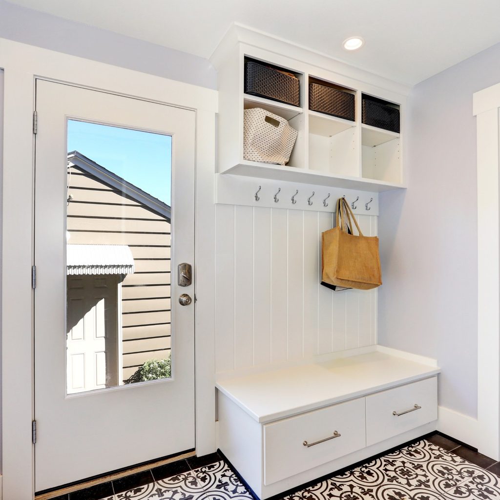 Storage bench with cubby holes in foyer of home