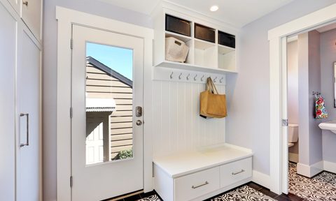 Storage bench with cubby holes in foyer of home