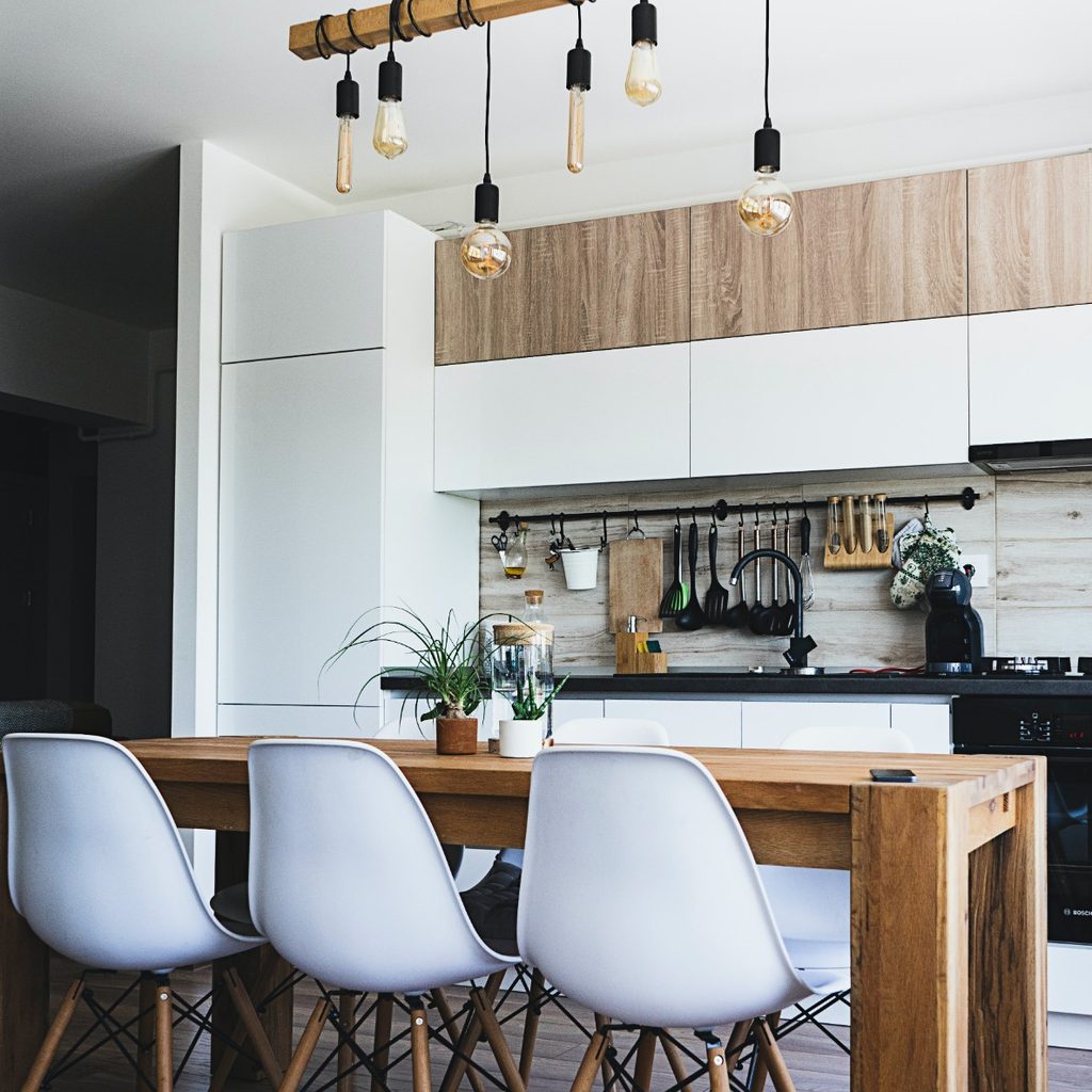 Kitchen with wooden table, chairs, and overhead lights