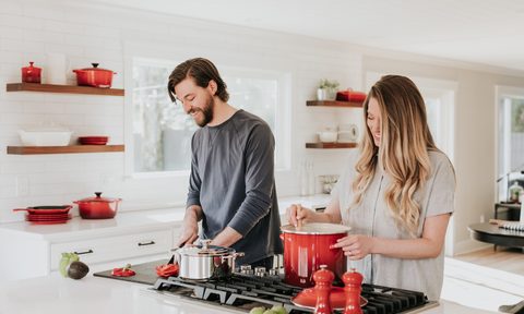 retro kitchen ideas man and woman at stove in with red decor