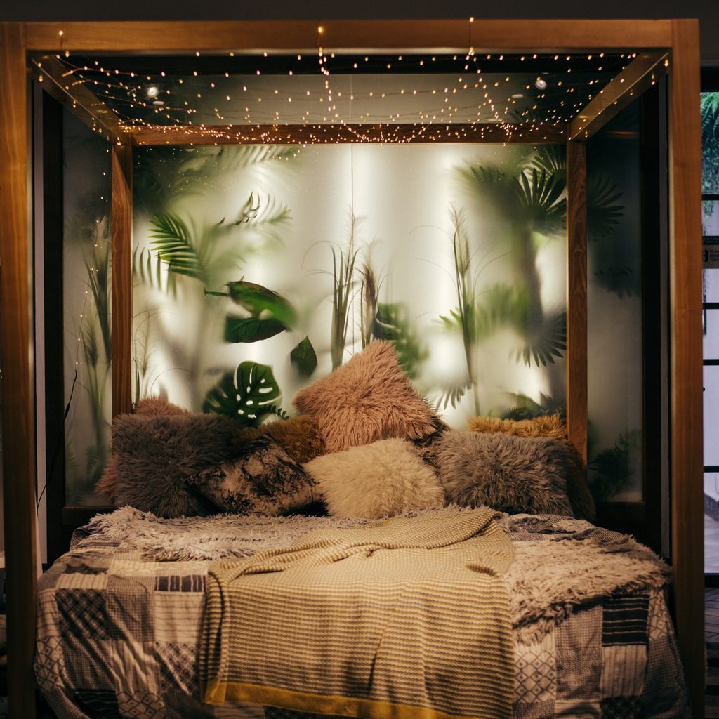 Fancy bed with many pillows and hanging lights