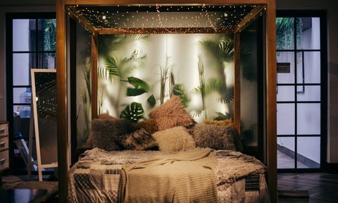 Fancy bed with many pillows and hanging lights