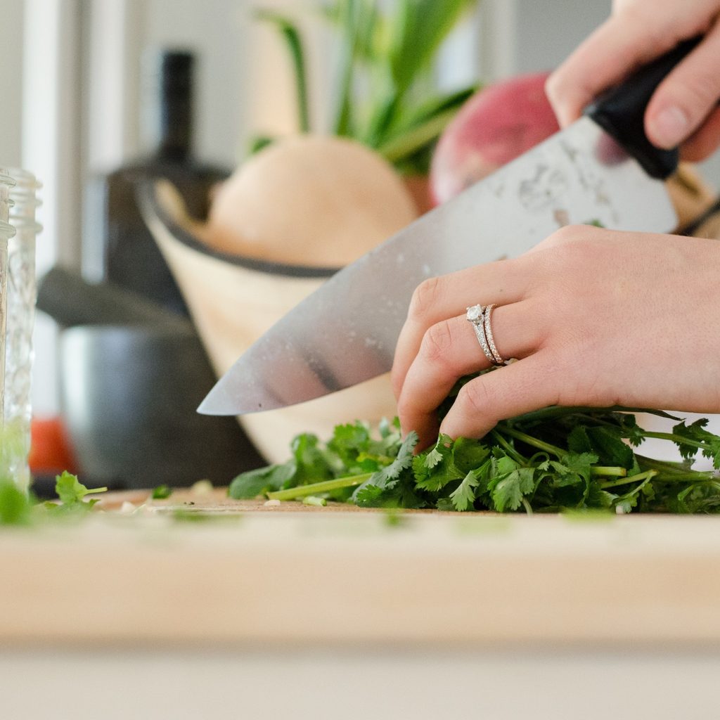 Close-up of a hand chopping vegatables