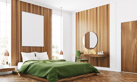 Bedroom with bed, desk, and round mirror