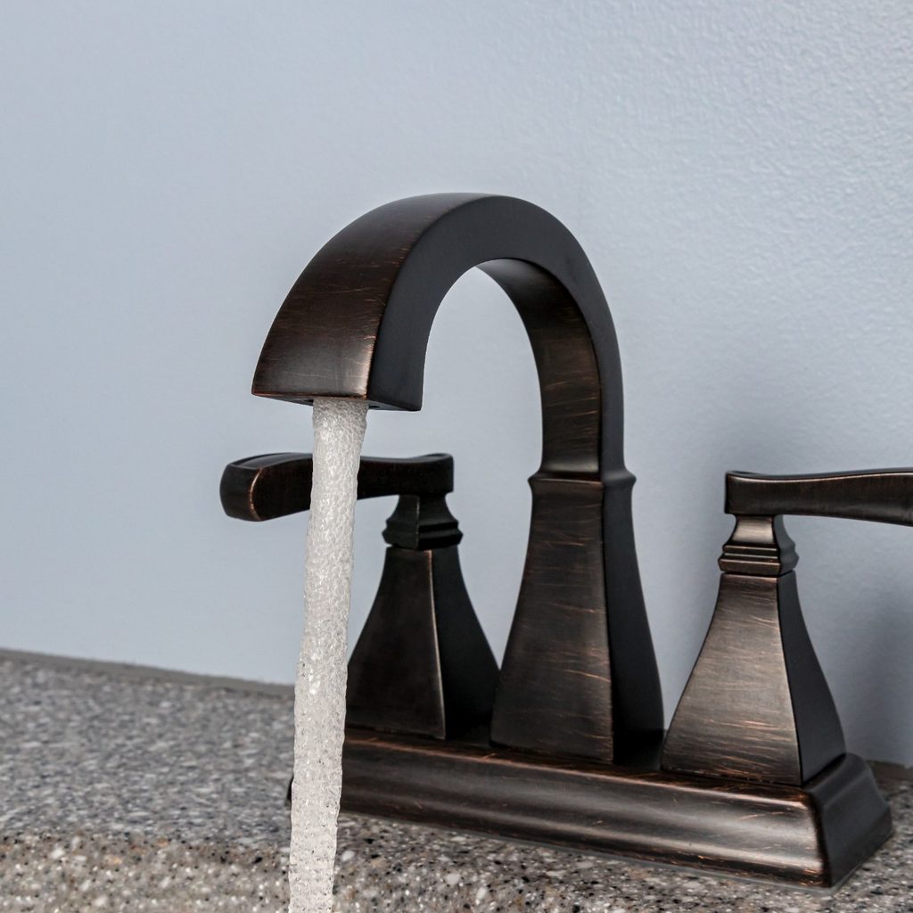 Black bathroom faucet with water running