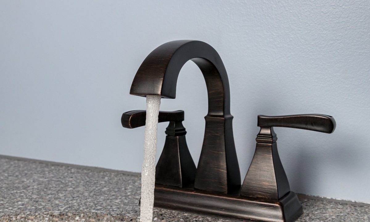 Black bathroom faucet with water running