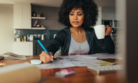 Woman working at desk of her home office