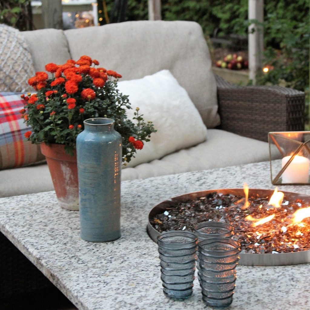 Patio with table, fire pit, and padded chair,