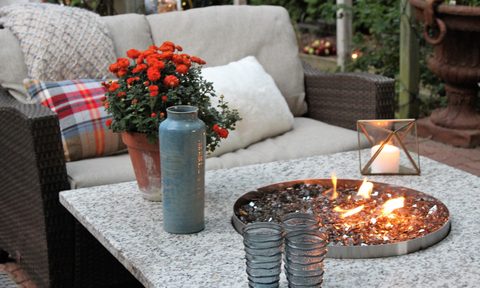 Patio with table, fire pit, and padded chair,