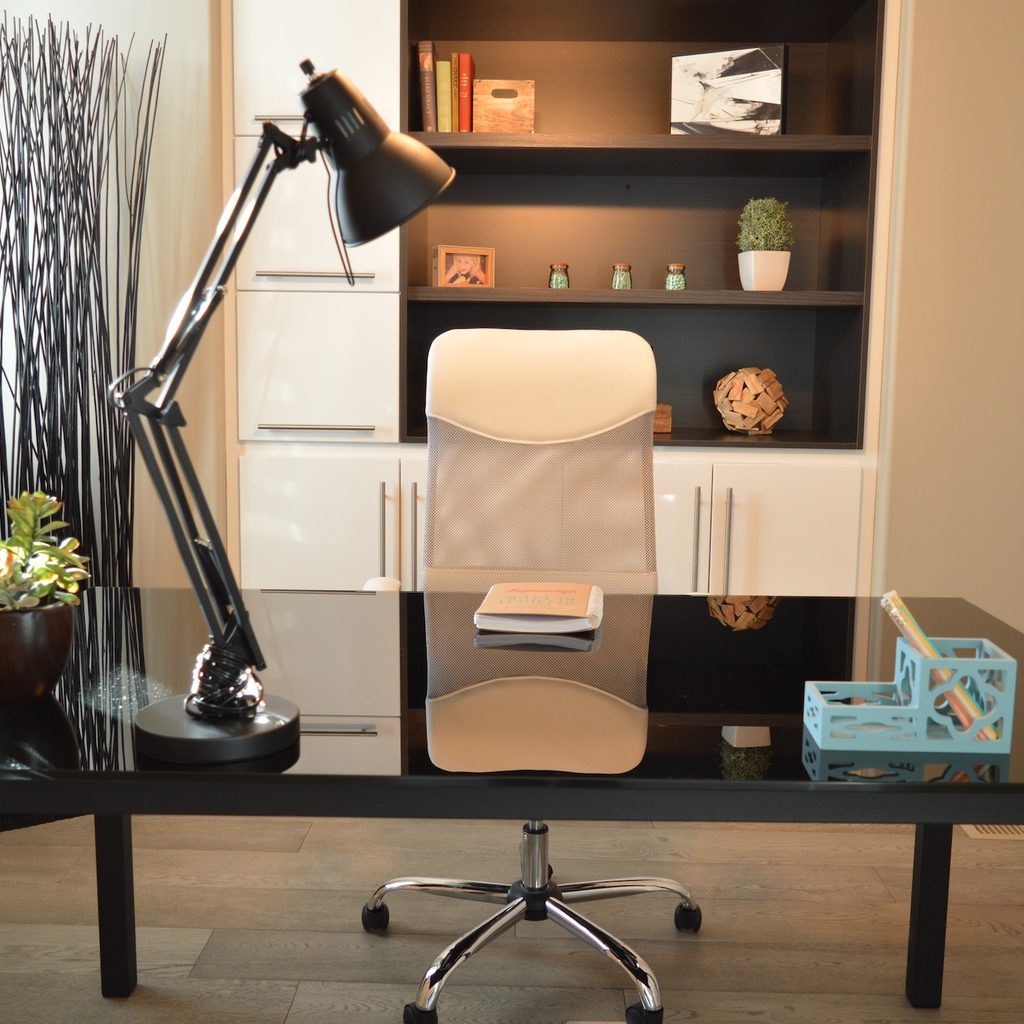sleek home office with modern executive chair behind black desk