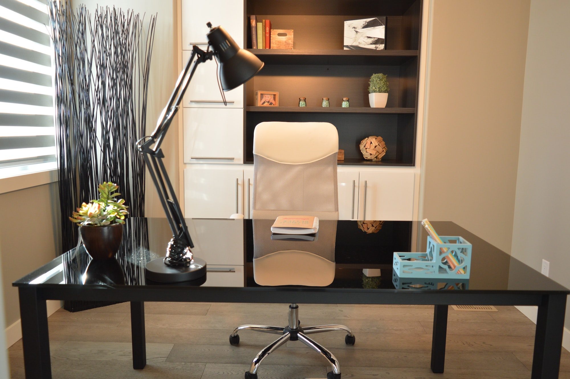 sleek home office with modern executive chair behind black desk