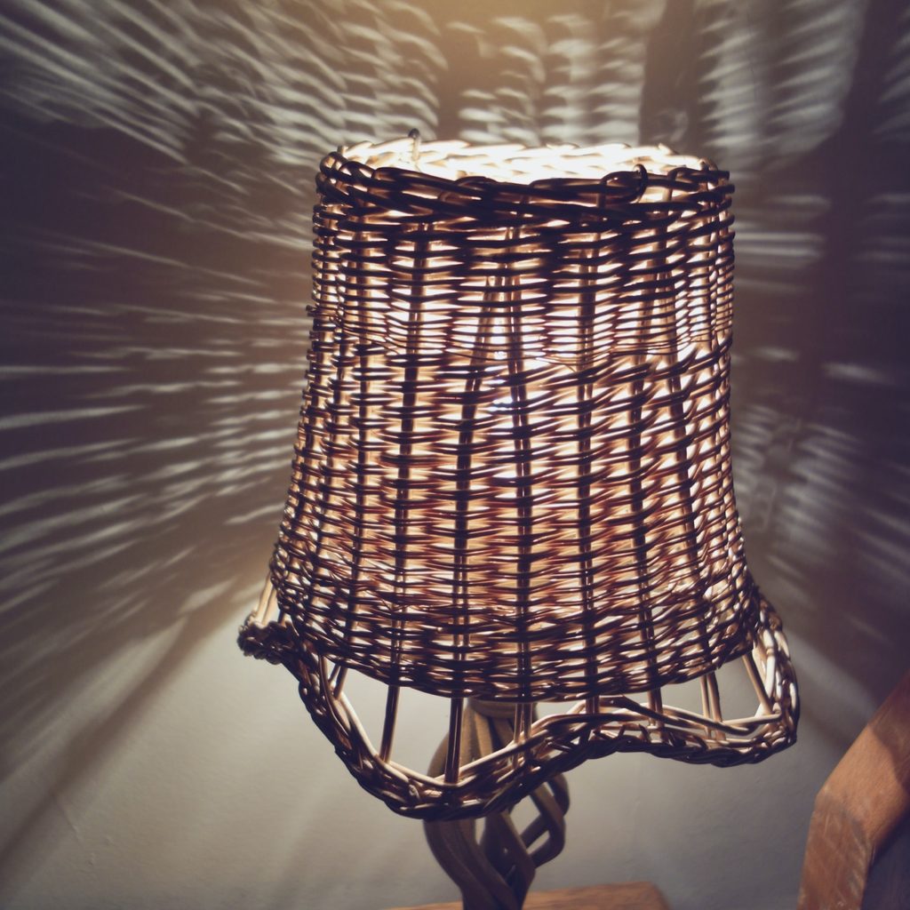 A woven basket lamp illuminates a room