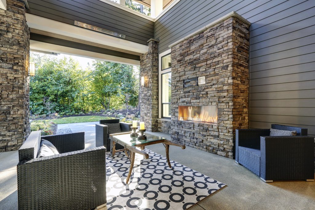 Outdoor patio stone fireplace and seating