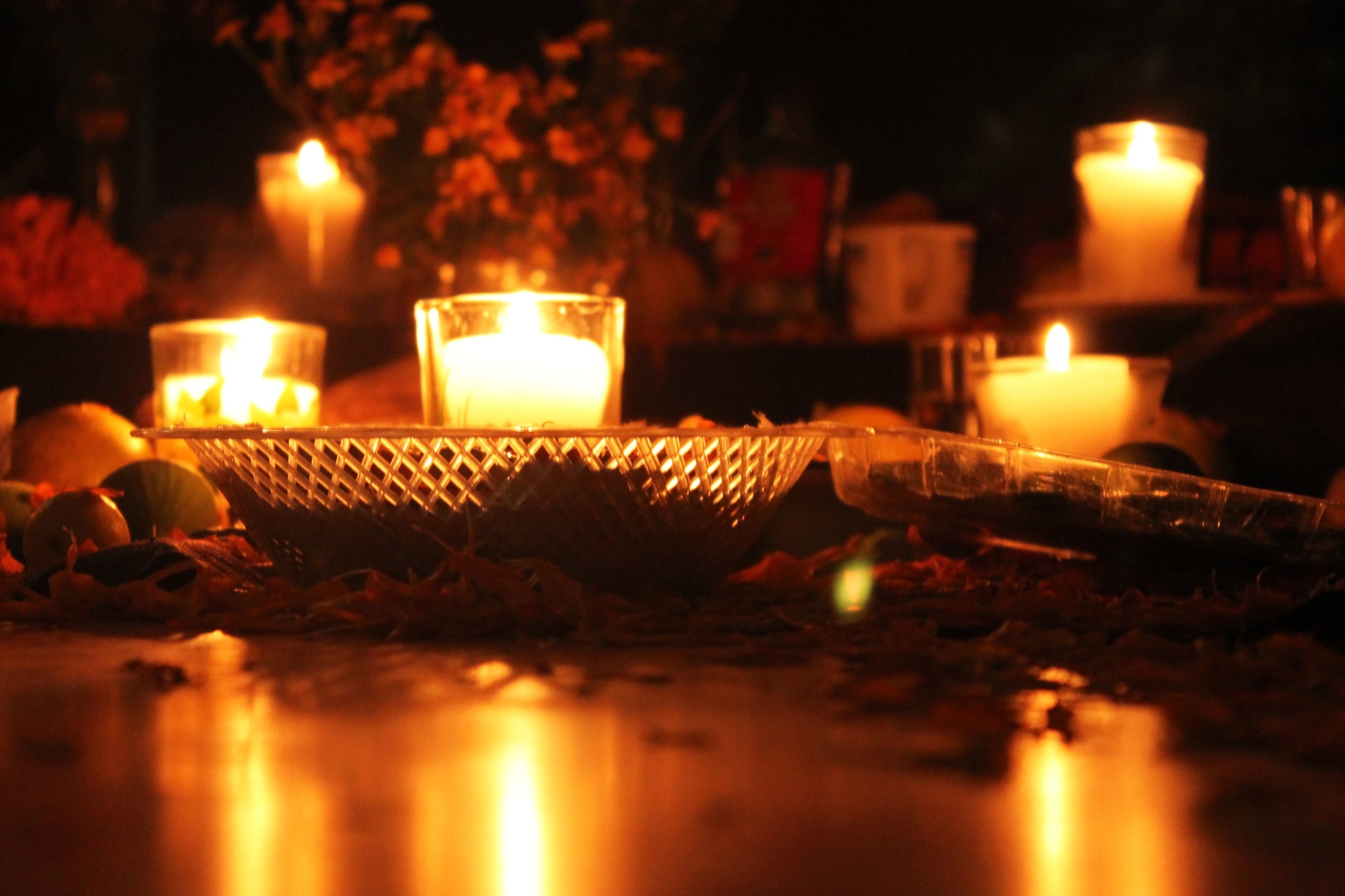 candles on an ofrenda for dia de los muertos