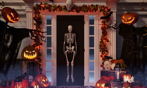 Front door decorated with a skeleton for Halloween