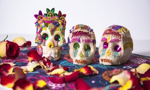 sugar skulls on a table for dia de los muertos