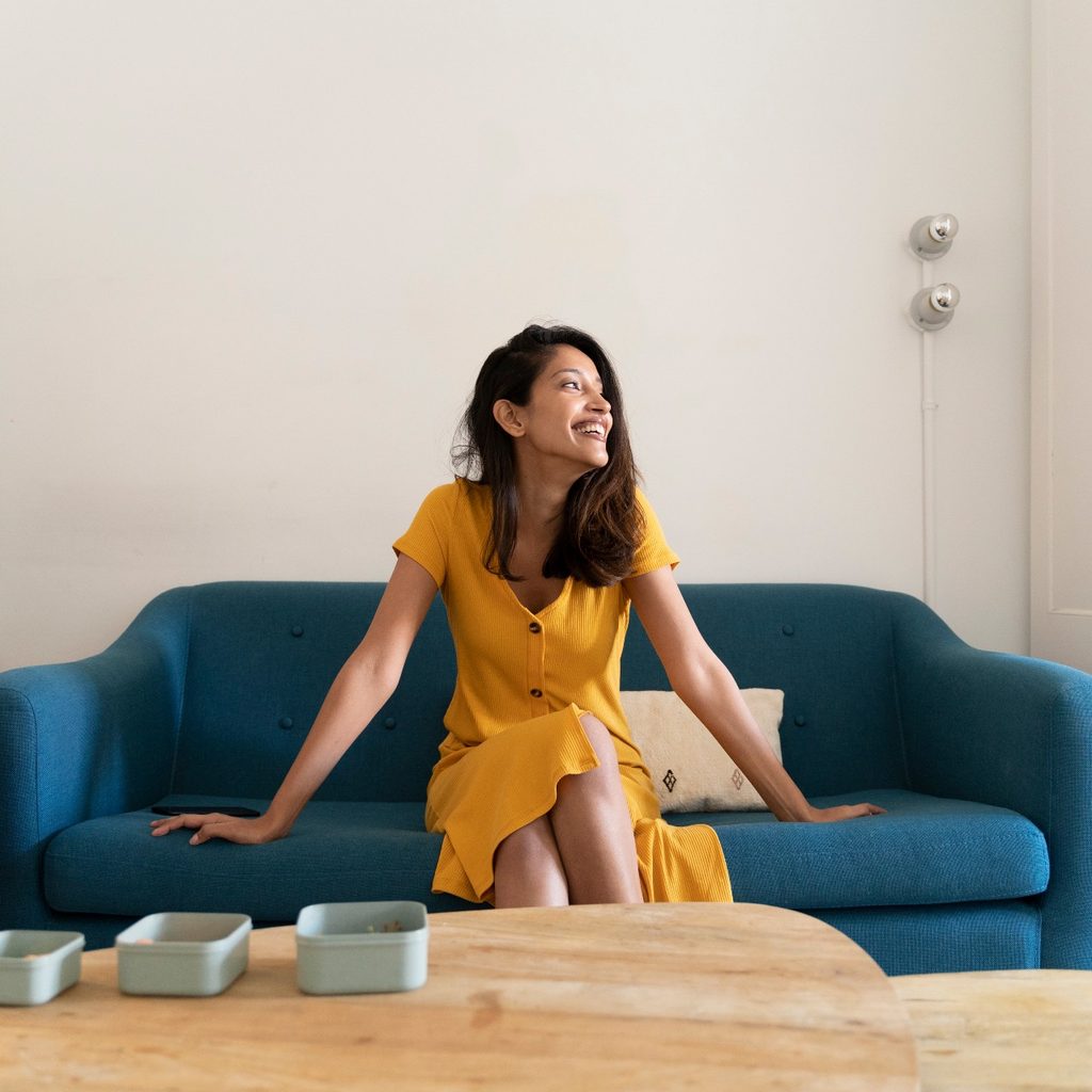 Woman sitting on a sofa near a coffee table