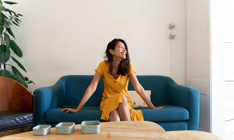 Woman sitting on a sofa near a coffee table
