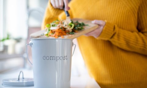 woman composting in kitchen