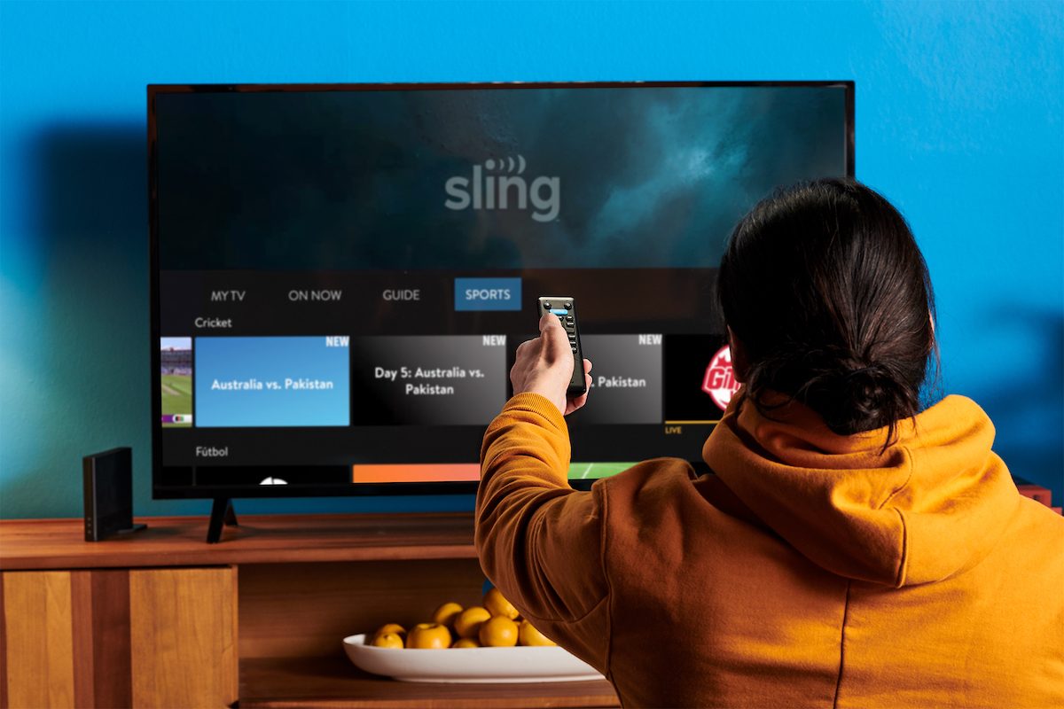 Man using his remote to watch Sling TV