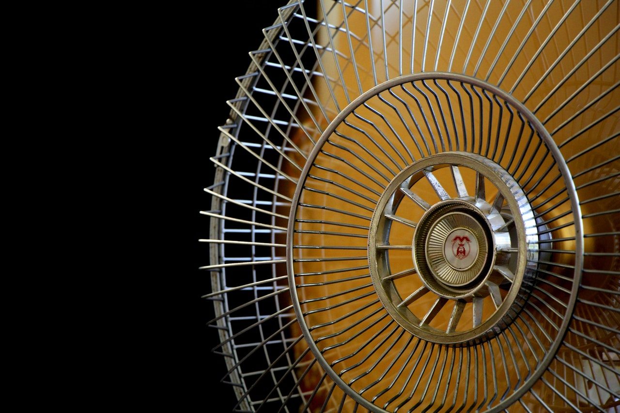 Yellow electric fan with black background