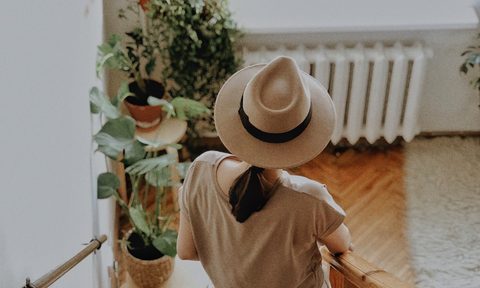 Woman on plant-filled stairwell