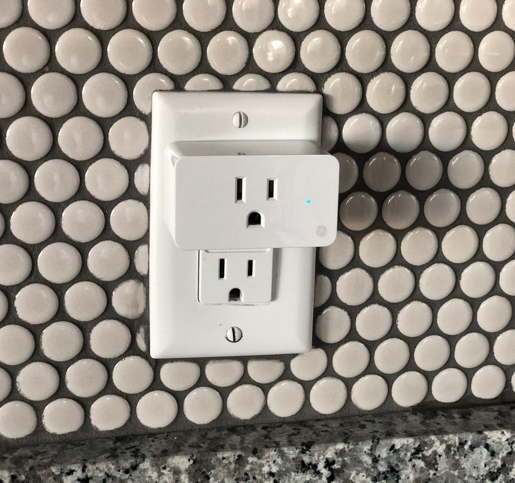 White electrical outlet on polka dot wall